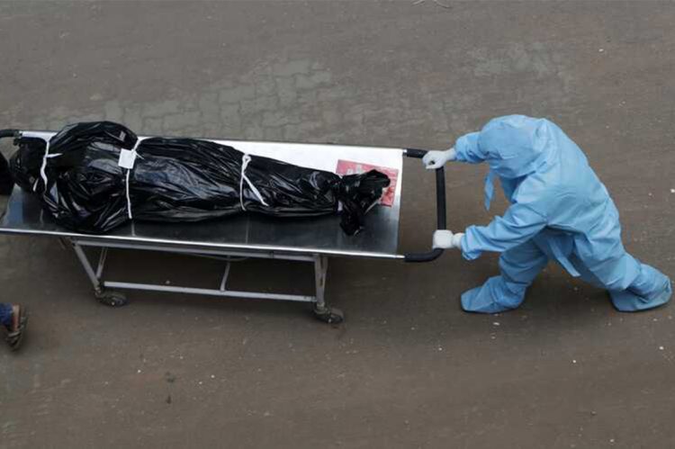 Hospital staff carry the body of a person who died of COVID-19 to a morgue in Mumbai, India, Friday, May 29, 2020. Most of the over 150,000 cases are concentrated in five of India’s 28 states, though an increase in cases has also been reported in some eastern states as migrant workers have begun arriving home from big cities on special trains. (AP Photo/Rajanish Kakade)