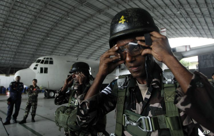 Sri Lankan air force paratroopers get ready for an exercise of Pacific Air Lift Rally 2011 at an air force base in Ratmalana, a suburb of Colombo, Sri Lanka, Wednesday, Aug. 24, 2011. The Rally aimed at exhibiting and rehashing air rescue missions, mainly air drops and lifting was attended by air force personnel from United States, Australia, Malaysia and Sri Lanka.(AP Photo/ Eranga Jayawardena)