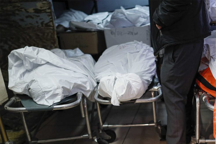 Pat Marmo, owner of Daniel J. Schaefer Funeral Home, walks through his body holding facility that is struggling to handle overflow of clients stemming from COVID-19 deaths, Thursday, April 2, 2020, in the Brooklyn borough of New York. "This is a state of emergency," he said. "We need help." (AP Photo/John Minchillo)