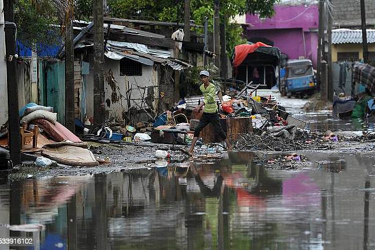 A Sri Lankan resident walks through floodwaters in the Kolonnawa suburb of Colombo on May 24, 2016.
Sri Lankans camped out in shelters in the capital face an uncertain future after massive flooding from torrential rain struck the island, forcing them to flee their inundated homes. Water levels in Colombo are slowly falling after the Kelani river running through the city of 650,000 burst its banks early last week, and a cleanup is underway.
/ AFP / ISHARA S.KODIKARA (Photo credit should read ISHARA S.KODIKARA/AFP via Getty Images)
