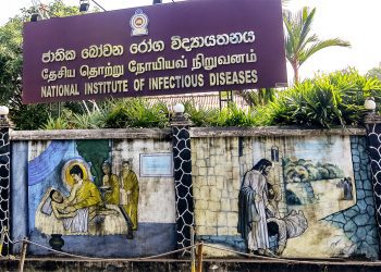 Mural wall paintings depicting Gautama Buddha treating an ill monk (L) and Jesus  Christ healing the sick are seen besides the entrance of the   National Institute of Infectious Diseases where the Corona Virus  (Covid-19) positive patients are treated in Colombo, Sri Lanka on 16 March 2019.   
28 people  have been tested positive for Covid-19 in Sri Lanka so far.
The Sri Lankan government declared a three-day holiday asking all non-essential businesses not to operate on March 17, 18 and 19 while asking some key government services and private businesses in banking, food transport, and distribution to operate. (Photo by Tharaka Basnayaka/NurPhoto via Getty Images)