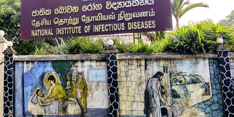 Mural wall paintings depicting Gautama Buddha treating an ill monk (L) and Jesus  Christ healing the sick are seen besides the entrance of the   National Institute of Infectious Diseases where the Corona Virus  (Covid-19) positive patients are treated in Colombo, Sri Lanka on 16 March 2019.   
28 people  have been tested positive for Covid-19 in Sri Lanka so far.
The Sri Lankan government declared a three-day holiday asking all non-essential businesses not to operate on March 17, 18 and 19 while asking some key government services and private businesses in banking, food transport, and distribution to operate. (Photo by Tharaka Basnayaka/NurPhoto via Getty Images)