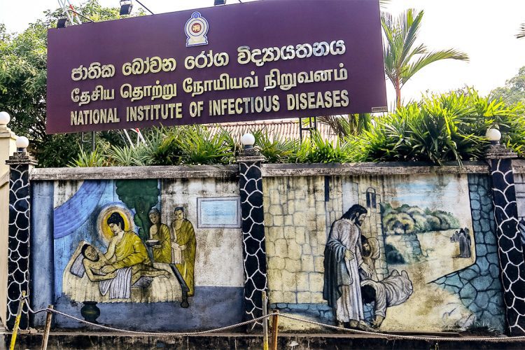 Mural wall paintings depicting Gautama Buddha treating an ill monk (L) and Jesus  Christ healing the sick are seen besides the entrance of the   National Institute of Infectious Diseases where the Corona Virus  (Covid-19) positive patients are treated in Colombo, Sri Lanka on 16 March 2019.   
28 people  have been tested positive for Covid-19 in Sri Lanka so far.
The Sri Lankan government declared a three-day holiday asking all non-essential businesses not to operate on March 17, 18 and 19 while asking some key government services and private businesses in banking, food transport, and distribution to operate. (Photo by Tharaka Basnayaka/NurPhoto via Getty Images)