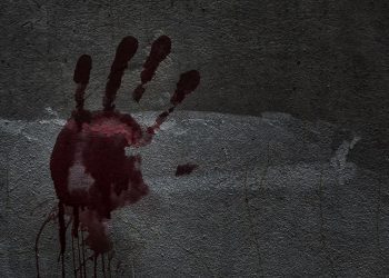 Blood of hand on a wall in an abandoned house them.The story about the murder.Background operators in Halloween festivities.