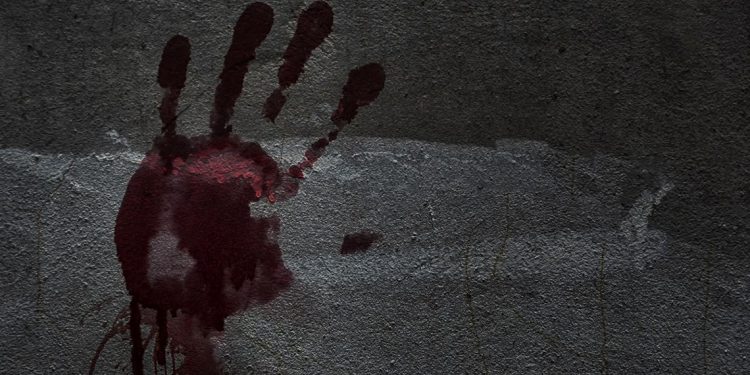Blood of hand on a wall in an abandoned house them.The story about the murder.Background operators in Halloween festivities.