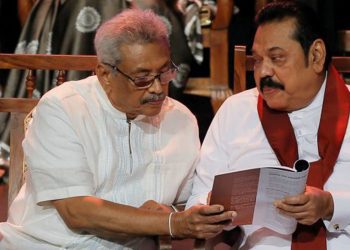 Sri Lanka, October 25 (ANI): Sri Lanka People's Front party presidential election candidate and former wartime defence chief Gotabaya Rajapaksa and his brother former president and opposition leader Mahinda Rajapaksa looks at the manifesto book during it's launching ceremony in Colombo on Friday. (REUTERS Photo)
