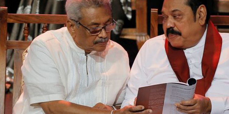 Sri Lanka, October 25 (ANI): Sri Lanka People's Front party presidential election candidate and former wartime defence chief Gotabaya Rajapaksa and his brother former president and opposition leader Mahinda Rajapaksa looks at the manifesto book during it's launching ceremony in Colombo on Friday. (REUTERS Photo)