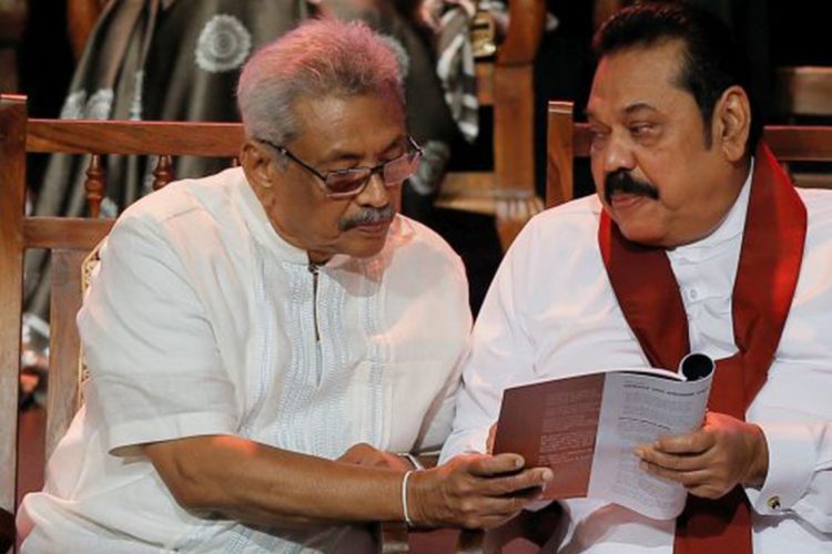 Sri Lanka, October 25 (ANI): Sri Lanka People's Front party presidential election candidate and former wartime defence chief Gotabaya Rajapaksa and his brother former president and opposition leader Mahinda Rajapaksa looks at the manifesto book during it's launching ceremony in Colombo on Friday. (REUTERS Photo)