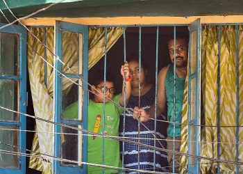 Kolkata: A family looks from the window of a house during the nationwide lockdown imposed to contain the coronavirus pandemic, in Kolkata, Tuesday, March 31, 2020. (PTI Photo/Swapan Mahapatra) (PTI31-03-2020_000112B)