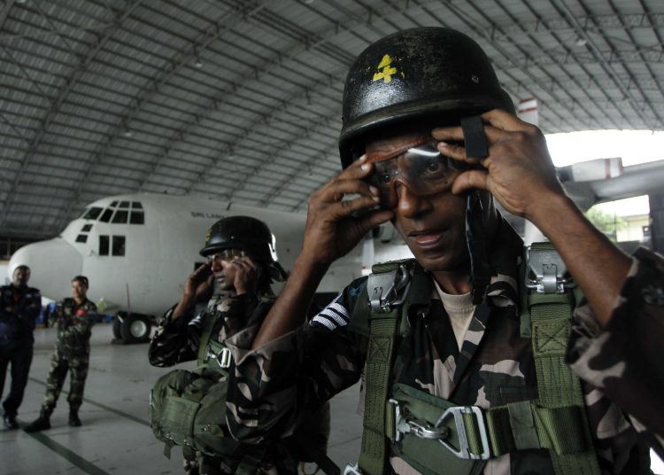 Sri Lankan air force paratroopers get ready for an exercise of Pacific Air Lift Rally 2011 at an air force base in Ratmalana, a suburb of Colombo, Sri Lanka, Wednesday, Aug. 24, 2011. The Rally aimed at exhibiting and rehashing air rescue missions, mainly air drops and lifting was attended by air force personnel from United States, Australia, Malaysia and Sri Lanka.(AP Photo/ Eranga Jayawardena)