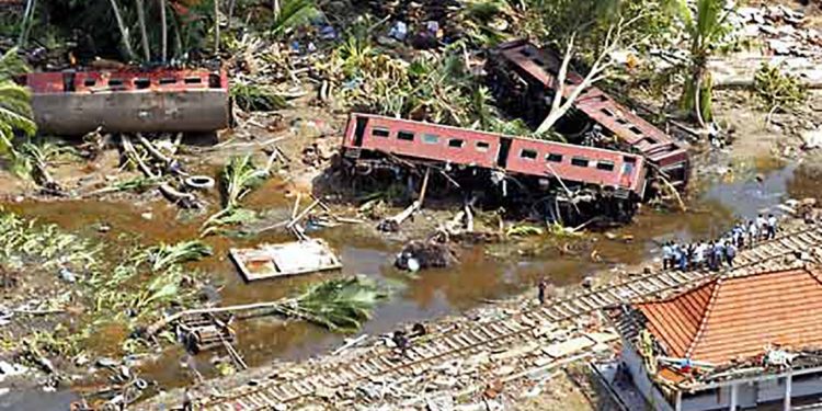 An aerial shot taken from a helicopter shows villagers search for the missing along railroad tracks at Telwatte, about 100 kilometers (63 miles) south of Colombo, Sri Lanka, Wednesday, Dec. 29, 2004. The massive tidal waves that slammed into Sri Lanka flung a train off its tracks, leaving many of its 1,000 passengers dead or missing, police said Tuesday.  Rescue workers reported another 3,009 deaths from Sunday's earthquake-triggered tsunami, lifting Sri Lanka's toll to 21,715, said the National Disaster Management Center.(AP Photo/Vincent Thian)