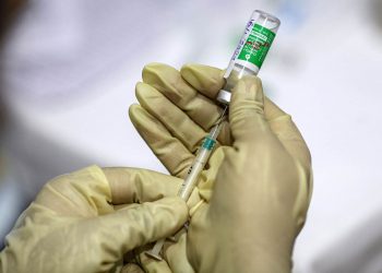 A nurse uses a syringe to draw from a vial of the Covishield vaccine, developed by Oxford-Astrazeneca Plc. and manufactured by Serum Institute of India Ltd., at a vaccine center in the Bandra Kurla Complex hospital in Mumbai, India, on Saturday, Jan. 16, 2021. India launched one of the worlds largest coronavirus vaccination drives on Saturday, setting in motion a complex deployment plan aimed at stemming the wide spread of infections across a nation of more than 1.3 billion people. Photographer: Dhiraj Singh/Bloomberg via Getty Images