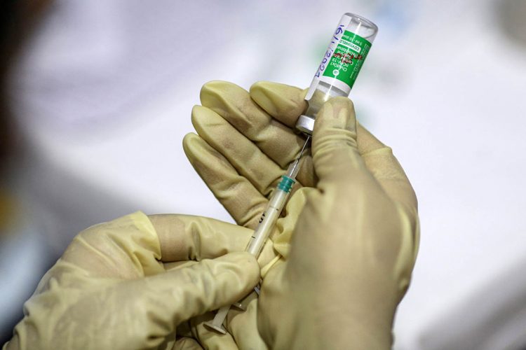 A nurse uses a syringe to draw from a vial of the Covishield vaccine, developed by Oxford-Astrazeneca Plc. and manufactured by Serum Institute of India Ltd., at a vaccine center in the Bandra Kurla Complex hospital in Mumbai, India, on Saturday, Jan. 16, 2021. India launched one of the worlds largest coronavirus vaccination drives on Saturday, setting in motion a complex deployment plan aimed at stemming the wide spread of infections across a nation of more than 1.3 billion people. Photographer: Dhiraj Singh/Bloomberg via Getty Images