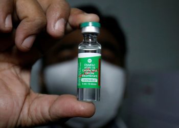 An official displays a vial containing COVISHIELD, a coronavirus disease (COVID-19) vaccine manufactured by Serum Institute of India, after a consignment of the vaccines arrived from the western city of Pune for its distribution, inside a vaccination storage centre in Ahmedabad, India, January 12, 2021. REUTERS/Amit Dave