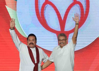 Sri Lankan opposition leader and former president  Mahinda Rajapaksa (L)  acknowledges supporters with his brother,  Sri Lanka's newly elected presidential candidate of Sri Lanka Podujana Peramuna and former defence secretary Gotabaya Rajapaksa at the annual general convention of the party at Colombo, Sri Lanka.
11 August 2019.  (Photo by Tharaka Basnayaka/NurPhoto via Getty Images)