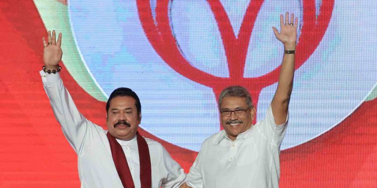 Sri Lankan opposition leader and former president  Mahinda Rajapaksa (L)  acknowledges supporters with his brother,  Sri Lanka's newly elected presidential candidate of Sri Lanka Podujana Peramuna and former defence secretary Gotabaya Rajapaksa at the annual general convention of the party at Colombo, Sri Lanka.
11 August 2019.  (Photo by Tharaka Basnayaka/NurPhoto via Getty Images)