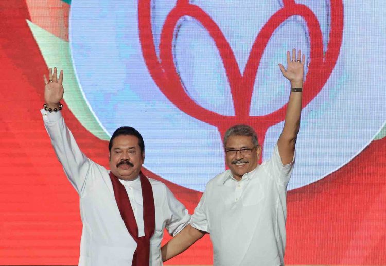 Sri Lankan opposition leader and former president  Mahinda Rajapaksa (L)  acknowledges supporters with his brother,  Sri Lanka's newly elected presidential candidate of Sri Lanka Podujana Peramuna and former defence secretary Gotabaya Rajapaksa at the annual general convention of the party at Colombo, Sri Lanka.
11 August 2019.  (Photo by Tharaka Basnayaka/NurPhoto via Getty Images)