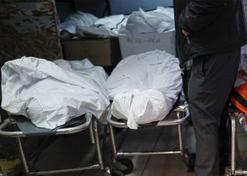 Pat Marmo, owner of Daniel J. Schaefer Funeral Home, walks through his body holding facility that is struggling to handle overflow of clients stemming from COVID-19 deaths, Thursday, April 2, 2020, in the Brooklyn borough of New York. "This is a state of emergency," he said. "We need help." (AP Photo/John Minchillo)