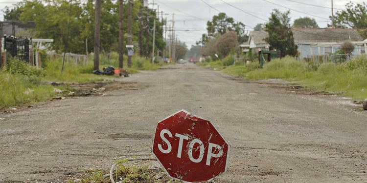 UNITED STATES - AUGUST 06:  A stop sign sits in a hole in a residential street in the Lower Ninth Ward of New Orleans, Louisiana, Sunday, August 6, 2006. U.S. President George W. Bush said last month the U.S. government has committed more than $110 billion to the recovery of the Gulf Coast, declaring "we've got a plan" for the hurricane-battered region, but almost a year after Hurricane Katrina struck, that plan is hard to discern.  (Photo by Daniel Acker/Bloomberg via Getty Images)