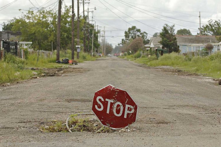 UNITED STATES - AUGUST 06:  A stop sign sits in a hole in a residential street in the Lower Ninth Ward of New Orleans, Louisiana, Sunday, August 6, 2006. U.S. President George W. Bush said last month the U.S. government has committed more than $110 billion to the recovery of the Gulf Coast, declaring "we've got a plan" for the hurricane-battered region, but almost a year after Hurricane Katrina struck, that plan is hard to discern.  (Photo by Daniel Acker/Bloomberg via Getty Images)