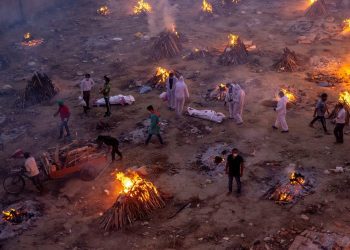 People wait to cremate victims who died due to the coronavirus disease (COVID-19), at a crematorium ground in New Delhi, India, April 23, 2021. REUTERS/Danish Siddiqui
