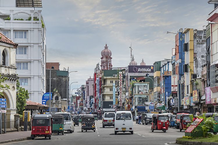 Sri Lanka, Colombo, May 6th 2018. Traditional tuc tuc (the local taxis) and modern cars in the traffic downtown Colombo.