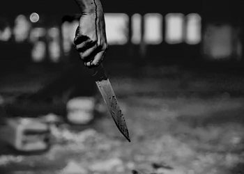 Woman hand holding bloody knife