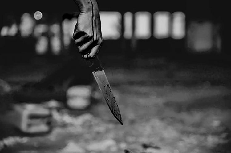Woman hand holding bloody knife
