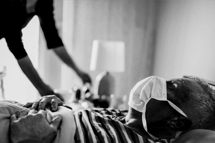 man has symptoms of the virus, lies in bed