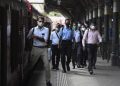 Commuters get off a train after arriving at Fort Railway station in Colombo on May 26, 2020 as authorities eased the 24-hour curfew as a preventive measure against the spread of the COVID-19 coronavirus after 67 days. - The 24-hour curfew first imposed on March 20 was eased on May 26 and turned into a night-time curfew as the authorities announced that the spread of the coronavirus was largely under control. (Photo by Ishara S. KODIKARA / AFP)