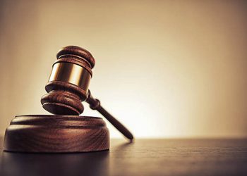 Gavel on desk. Isolated with good copy space. Dramatic lighting.