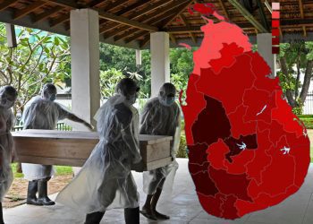 Municipal workers carry the coffin of an unclaimed body of a Covid-19 coronavirus victim to a crematorium in Colombo on December 10, 2020. (Photo by Lakruwan WANNIARACHCHI / AFP)