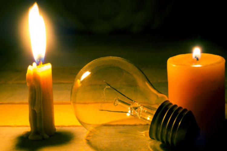 37170558 - candle light shine on incandescent bulb, no electricity  makes electrical equipment useless