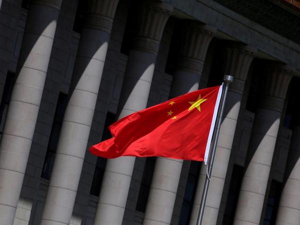 A Chinese flag flutters in front of the Great Hall of the People in Beijing, China, May 27, 2019. REUTERS/Jason Lee