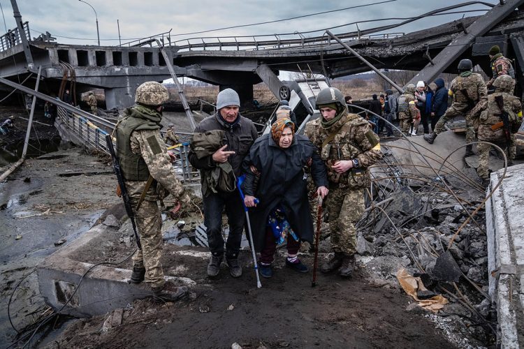Residents are evacuated from Irpin, on the outskirts of Kyiv, Ukraine, Saturday, March 5, 2022. The train station came under aerial attack, forcing hundreds of civilians waiting for trains to flee on foot.