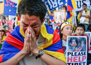 Pro-Tibetan demonstrators pray for human rights in Tibet during a protest outside the Chinese consulate in Sydney on March 18, 2008. About 100 demonstrators chanted "Free Tibet" or "Stop Killing"  and protest outside the Camperdown mission against violent unrest in Tibet without arrests. Days of protests over China's rule of Tibet turned into violent rioting in Lhasa last week and subsequently sparked pro-Tibet demonstrations around the world.  AFP PHOTO/Anoek DE GROOT (Photo credit should read ANOEK DE GROOT/AFP via Getty Images)