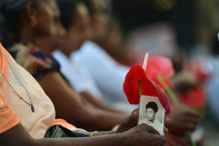 A Sri Lankan Tamil woman holds a picture of a loved one during a gathering to remember her loved one, who has been missing for nearly a decade since the end of the country's drawn out separatist war in the capital Colombo on February 14, 2018.
The women were marking what they called the missing lovers day to coincide with the Valentines Day to draw the spot light on thousands of people still listed as missing in the island despite the end of the war. / AFP PHOTO / ISHARA S. KODIKARA        (Photo credit should read ISHARA S. KODIKARA/AFP via Getty Images)