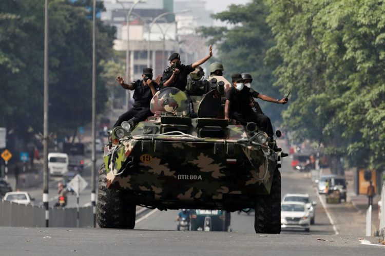 Army members travel on an armoured car on the main road after the curfew was extended for another extra day following a clash between Anti-government demonstrators and Sri Lanka's ruling party supporters, amid the country's economic crisis, in Colombo, Sri Lanka, May 11, 2022. REUTERS/Dinuka Liyanawatte