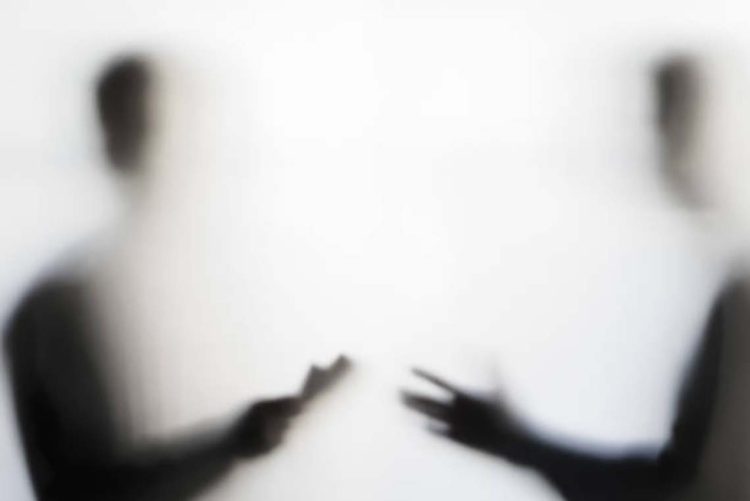 Two men making dubious nogotiation behind a curtain concept