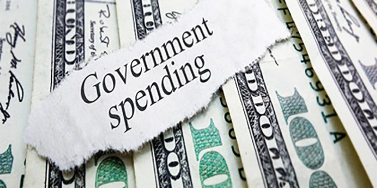 Government Spending newspaper headline on assorted money