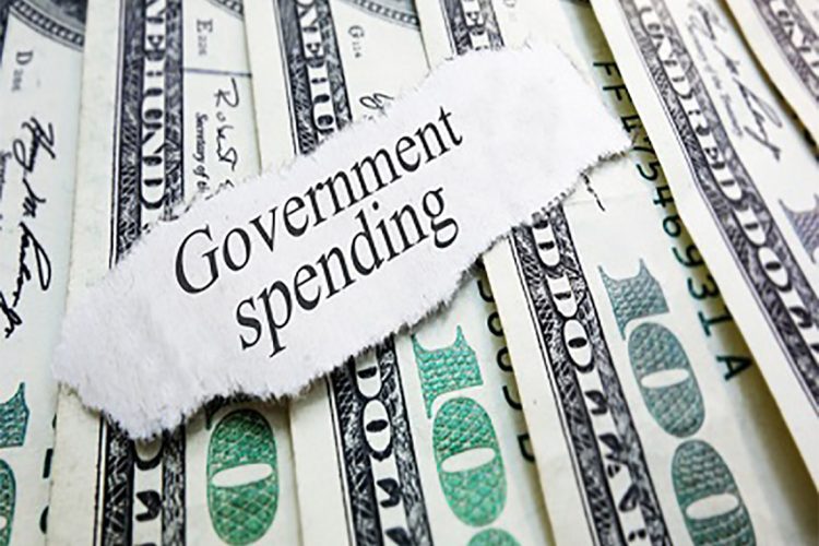 Government Spending newspaper headline on assorted money