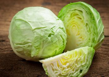 cabbage and cutted cabbage on wooden