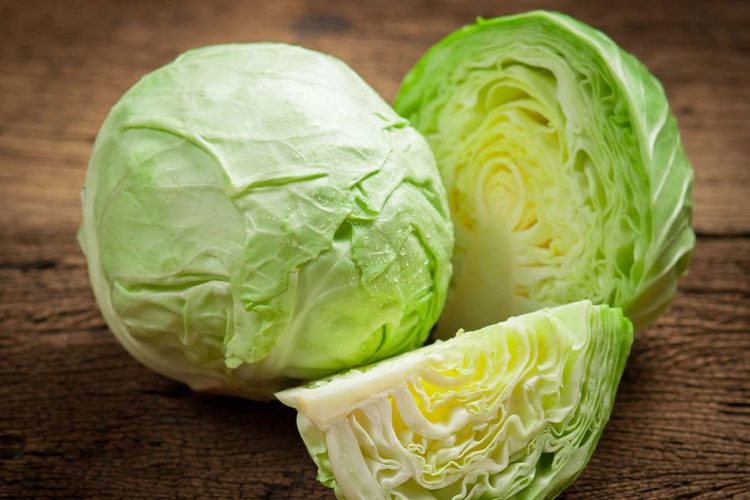 cabbage and cutted cabbage on wooden