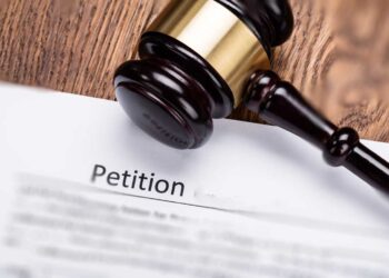 Wooden Gavel On Petition For Divorce Paper At Wooden Desk In Courtroom