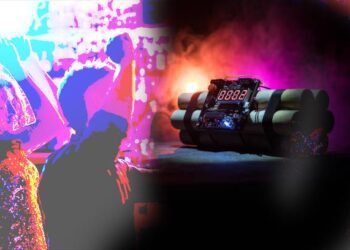 Image of a time bomb against dark background. Timer counting down to detonation illuminated in a shaft light shining through the darkness, conceptual image