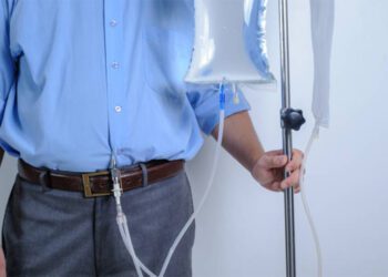 Peritoneal Dialysis user with catheter and saline bag