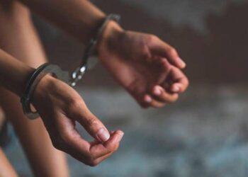 RECORD DATE NOT STATED close-up of hands in handcuff, Female prisoner, Arrested woman handcuffed hands. Prisoner or arrested terrorist, hacker, bribetaker. xFotosearchxLBRFx xTinnakornx Model Released ESY-056914070
