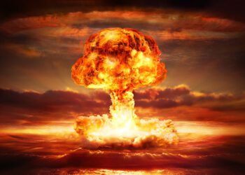 testing of atomic bomb over ocean with mushroom clouds - red destroy