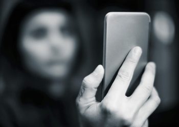 Girl with blue hair using smartphone