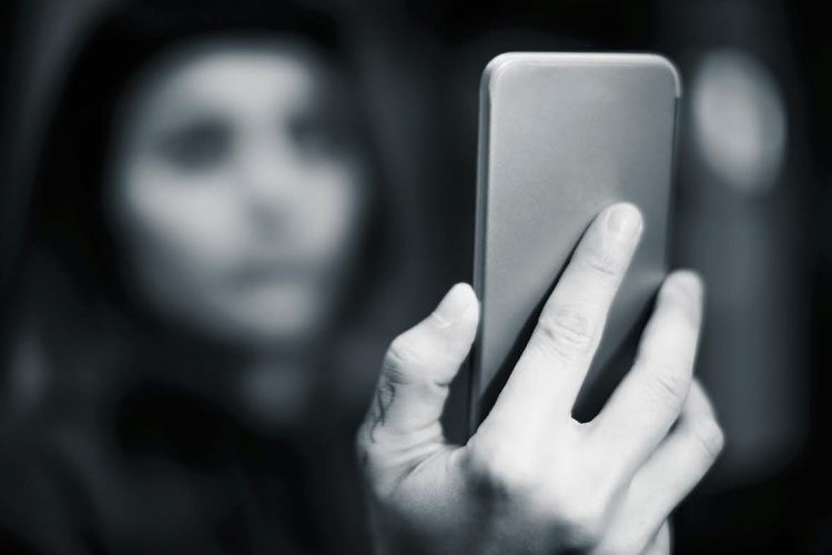 Girl with blue hair using smartphone
